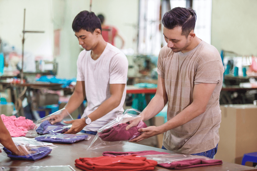 Men packaging clothes in a ready-to-wear clothing factory.