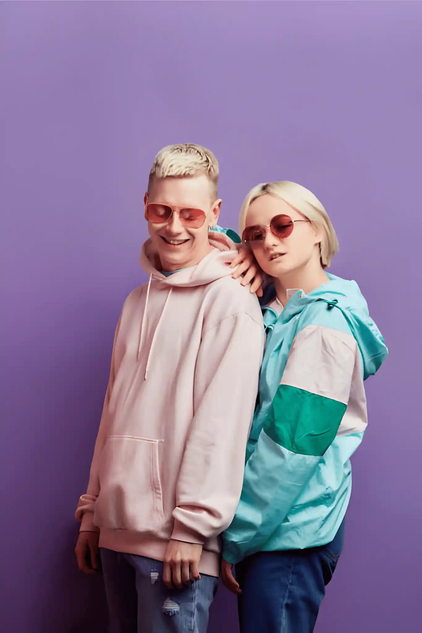 Two young people in a studio photoshoot.